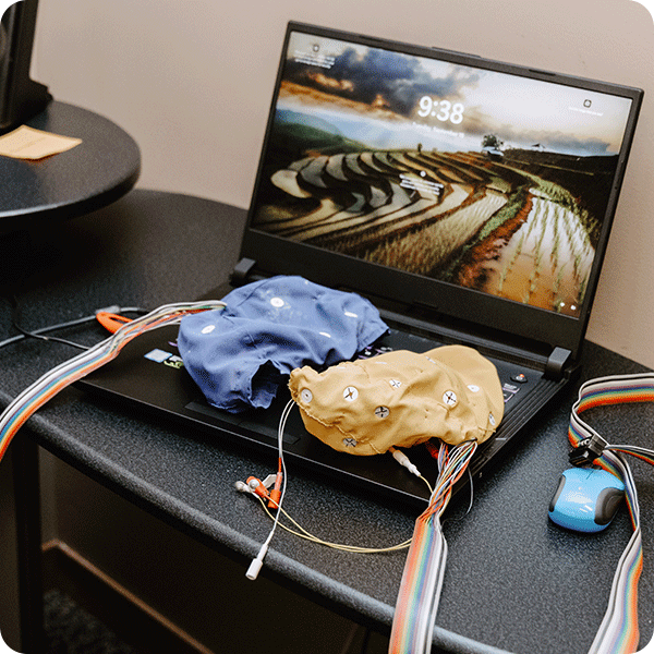 Brainmaster neurofeedback caps sit on top of a laptop keyboard