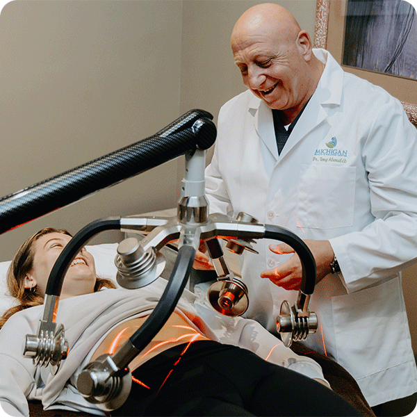 Doctor Tony performs cold laser therapy to female patient's stomach