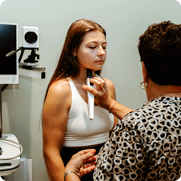 Shirley performs thermometry therapy under female patient's jaw
